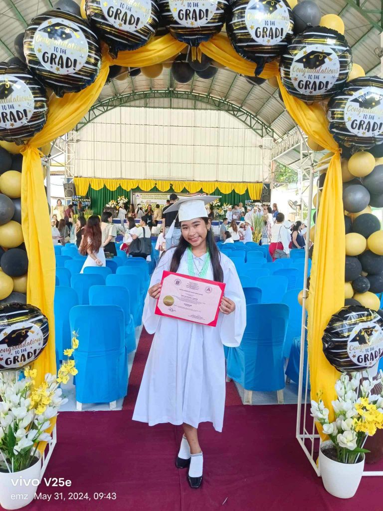 Girl Happily Smiles with her Graduation Certificate