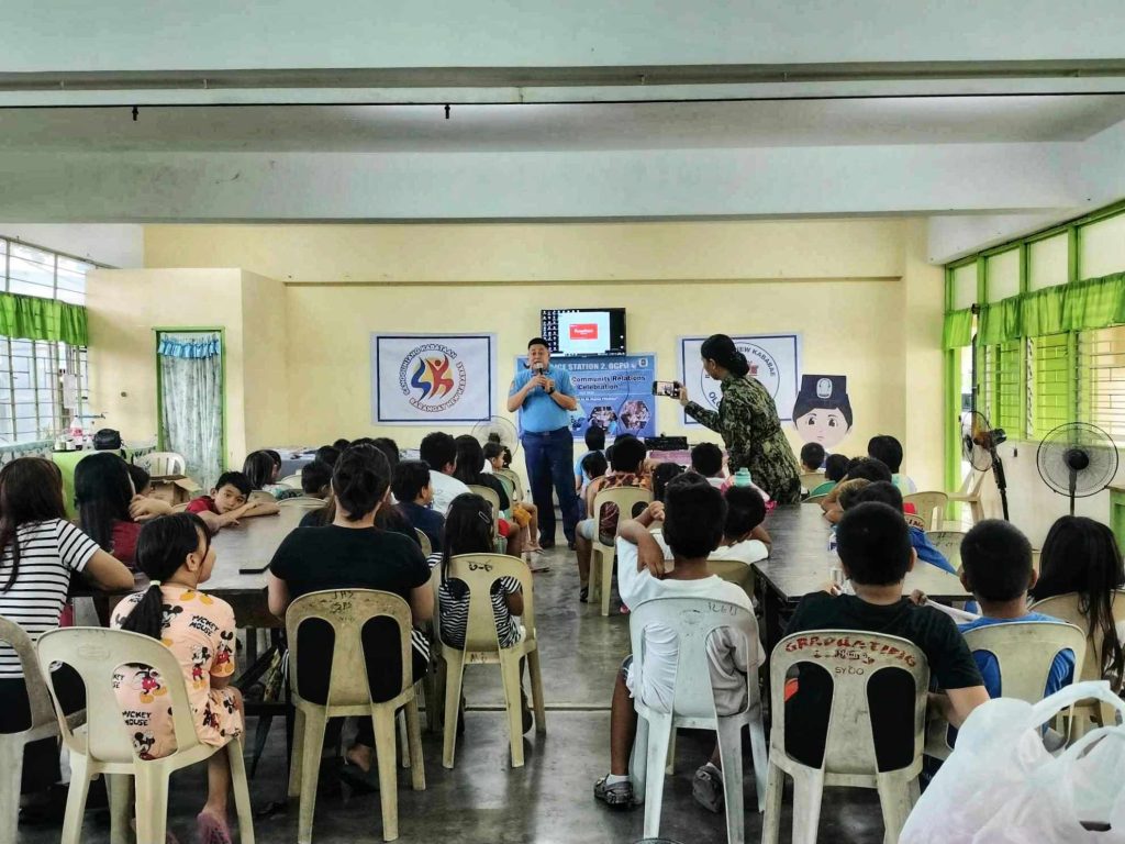 Classroom with students and police officer talking in front