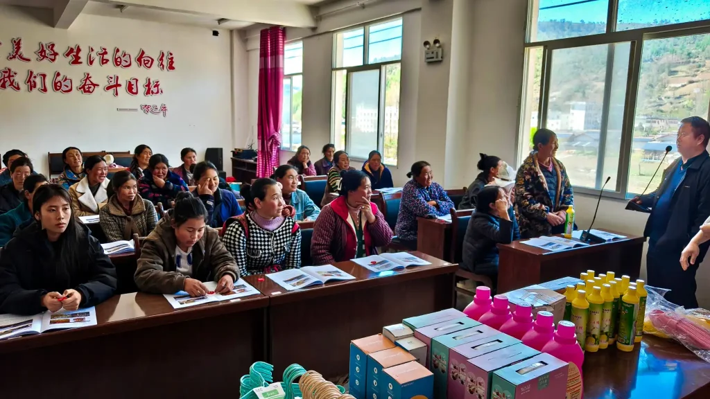 A diverse group of individuals sitting at desks in a classroom, participating in an educational setting.