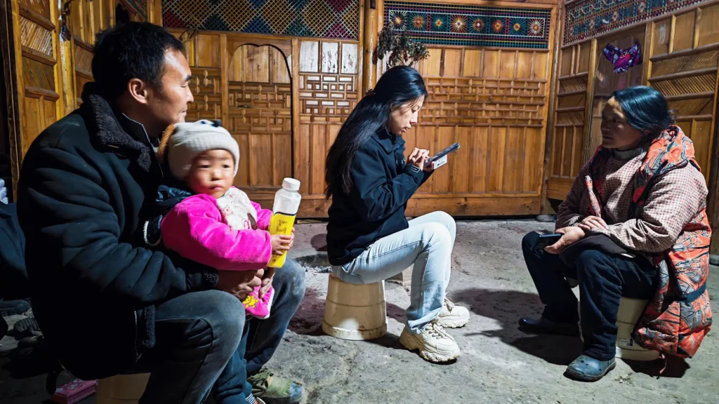 A staff member and a family gathered on the floor.