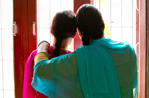 Two Nepali Women looking out the window together