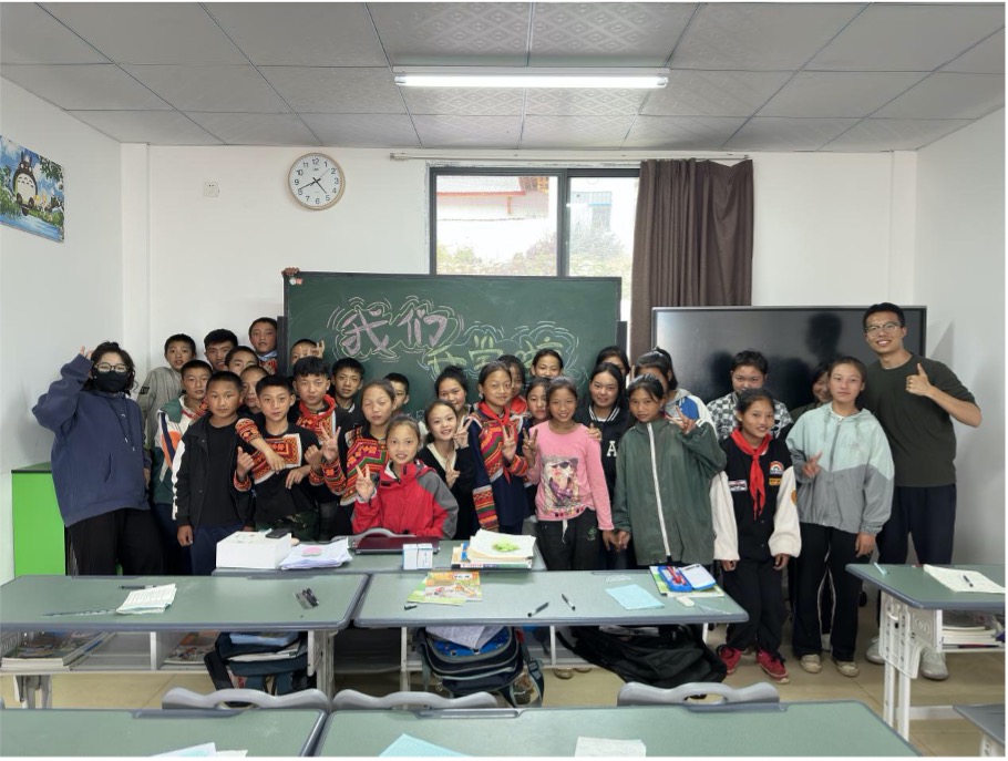 Teacher Zhu smiling with his students in the classroom