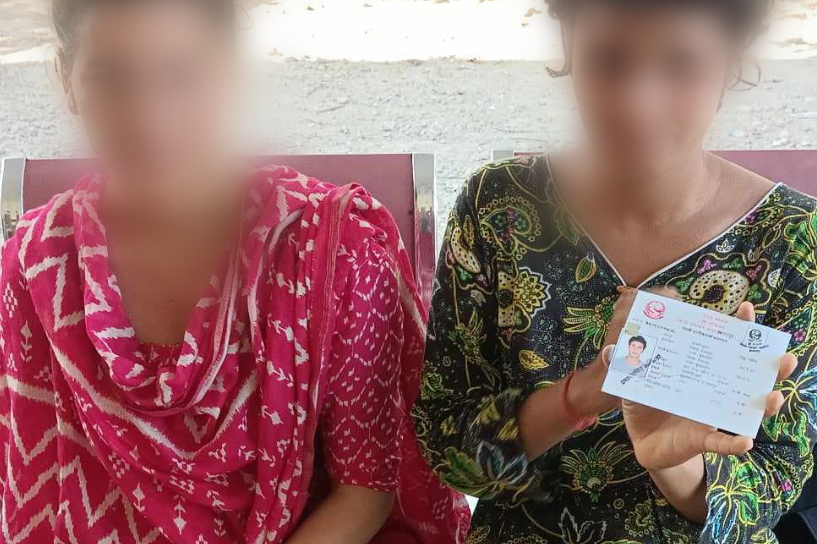 Woman Holds Up Citizenship Card