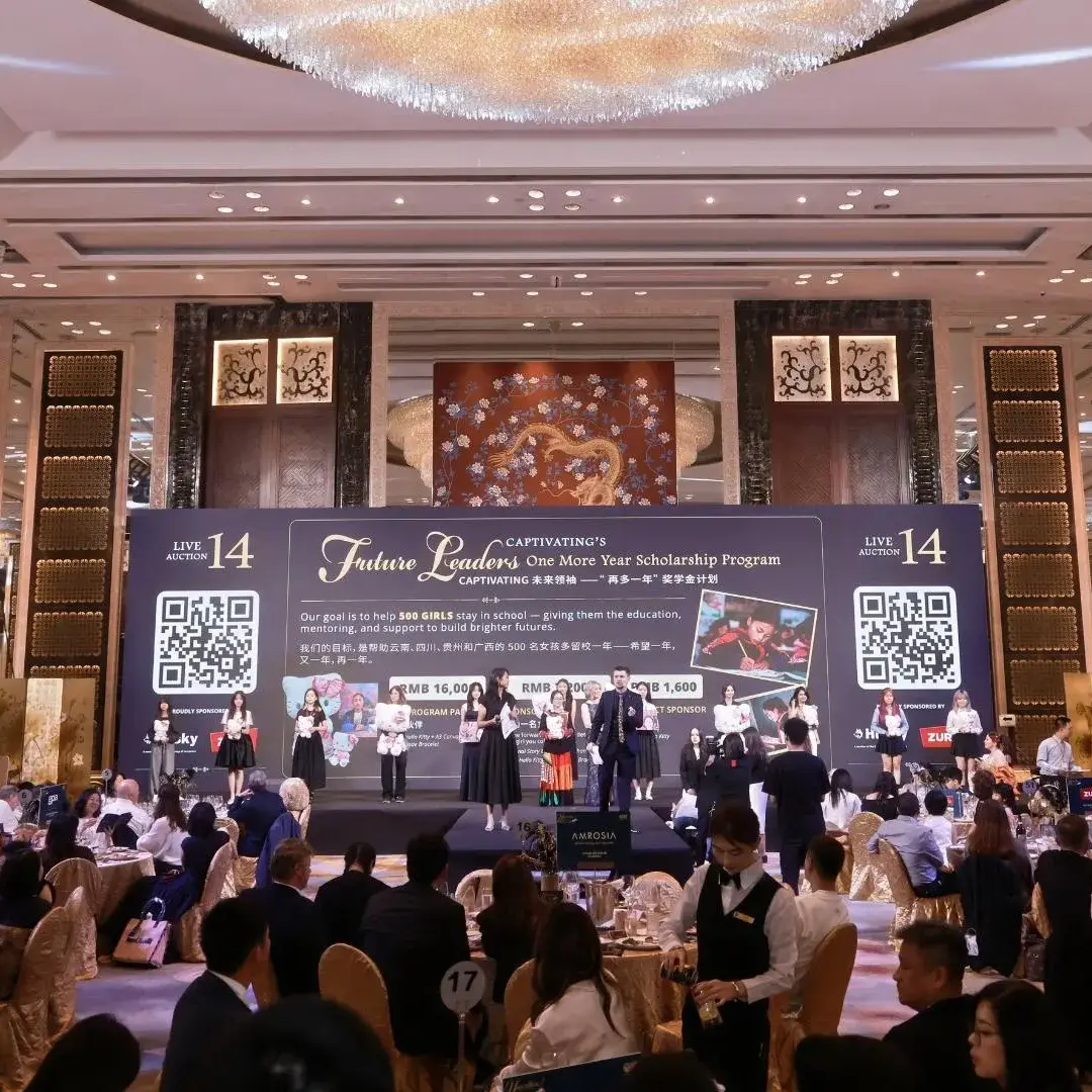 A gala event features a large stage with a banner for the Future Leaders scholarship program, with guests seated at round tables in a ballroom.