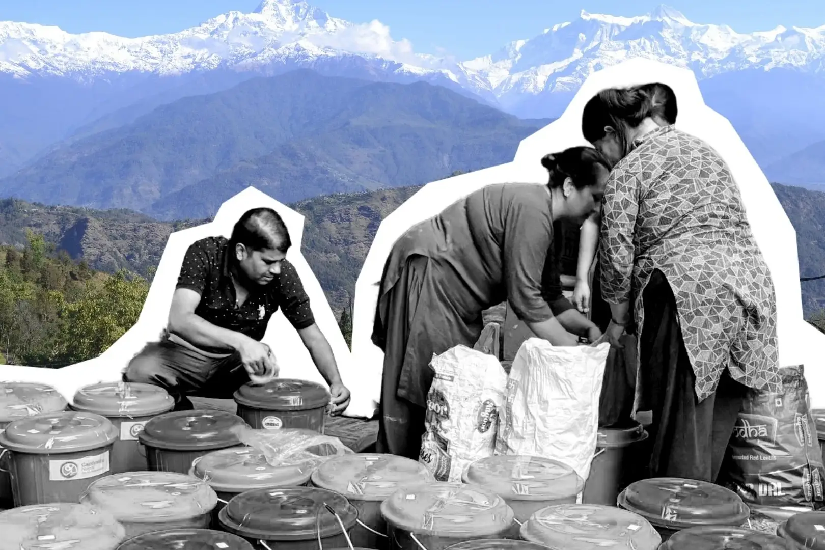 A man and two women work with many plastic containers and sacks against a backdrop of snow-capped mountain peaks in a bright, outdoor setting.