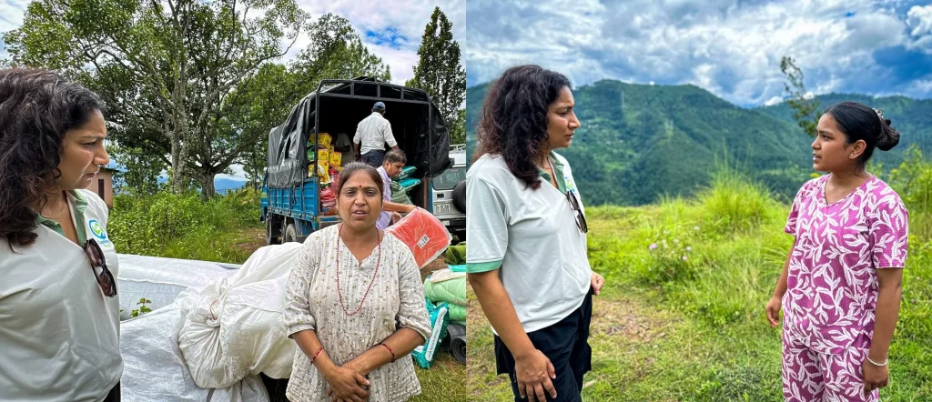 Volunteers and a woman stand beside a truck loaded with sacks in a lush mountain landscape; two women converse, conveying a caring relief effort.