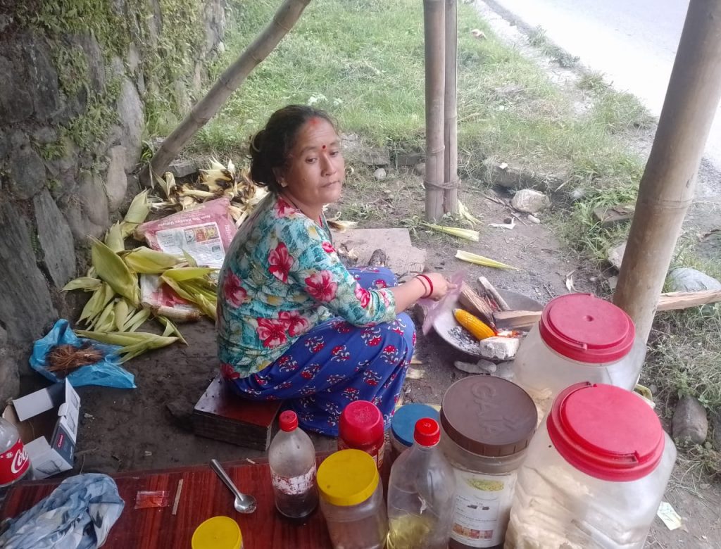 Woman in her small tin store hut