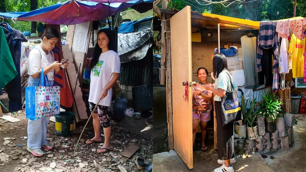 Two individuals stand outside their homes in a slum area in the Philippines, engaged in conversation during an interview.